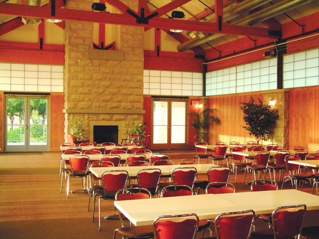 Clubhouse interior with tables and fireplace